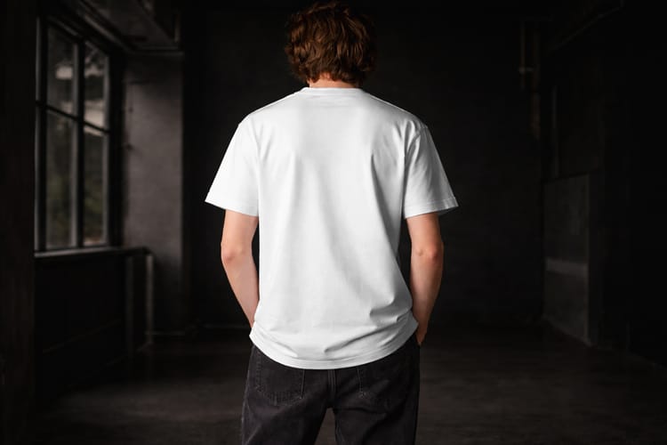 Back View T-Shirt Mockup on Male Model Urban Apparel Scene